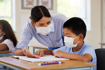 Image showing Covid, students and education teacher helping learning children in school classroom to answer math question. Woman with face mask teaching asian boy in lesson with diverse class of kids or classmates