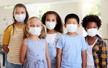 Image showing School kids, education and covid while wearing face masks in a classroom for protection against covid. Portrait of cute, young and smart students in safe learning and educational environment together