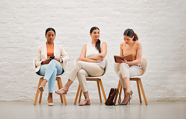 Image showing Employment, hiring and recruitment with business women waiting for an interview with human resources and sitting on chairs. Young female shortlist candidates doing research and preparing for meeting