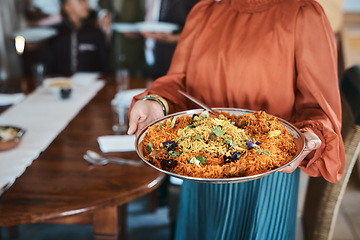 Image showing Food, dinner and consumables with a traditional paella dish in the hands of a woman at home. Closeup of a bowl of spanish sea food, ready to serve and feed hungry family for lunch or healthy supper