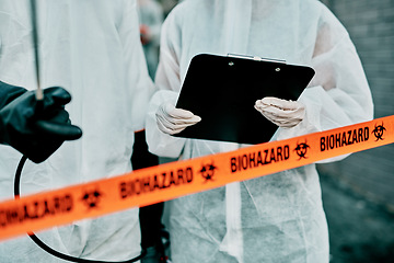 Image showing Covid, pandemic and team doctors, scientists or healthcare workers wearing protective ppe to prevent virus spread at quarantine site. First responders wearing hazmat suit while standing behind tape