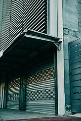 Image showing Building, architecture and urban background in a city, town or financial district outside during the day. A gate, entrance or barrier for access and entry to a modern metropolitan or suburban area