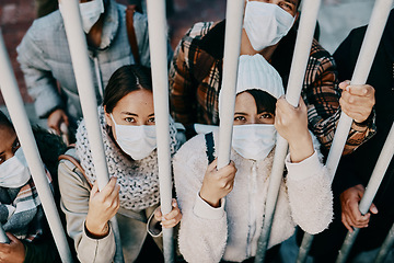 Image showing Covid travel ban, lockdown or border control to prevent spread of pandemic virus, contagious disease or illness. Portrait of prisoners in masks facing racism and discrimination behind locked gate