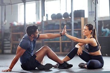 Image showing Gym wellness couple high five for success or good exercise and well done gesture for reaching fitness goal. Active trainer and client woman celebrating a great workout, training or exercising session