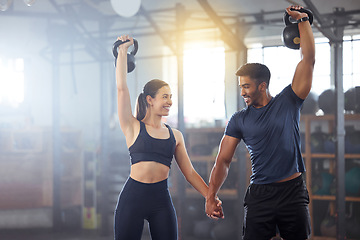 Image showing Fitness, kettlebell and couple in a workout exercise and holding hands in a gym. Fit sports people in a relationship with a strong grip, exercising with weight equipment to build muscle together.