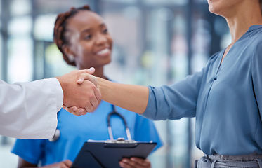 Image showing Doctors handshake thank you, greeting or good medical breakthrough success with smiling nurse in background. Physician, healthcare worker and patient shaking hands for innovation in health research