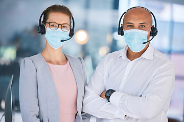 Image showing Customer service workers, with protection from covid and wearing masks for heath. Online support, IT or call center employees with headset, social distancing during corona virus pandemic or lockdown