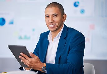 Image showing Successful financial businessman smiling while browsing on a digital tablet in the office. Portrait of a male professional accountant feeling positive after completing a deal or finishing a work task