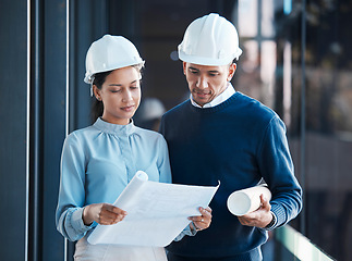 Image showing Architecture, civil and architect engineers busy with a floor plan or blueprint strategy on paper inside a office building. Designers working, planning and analyzing a construction project together