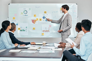 Image showing Business leader or coach presenting financial or marketing budget report, accounting statistics or sales charts on white board. Company finance growth strategy and project management team meeting.