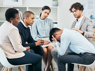 Image showing Depression, support and unity by colleagues comforting male after getting bad news at work. Community care from workers sitting together, supporting their friend after being fired or through grief