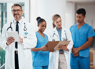 Image showing Portrait of a happy leader in a group of doctors and nurses planning surgery at the hospital. Medical team or healthcare professionals reading paperwork in a meeting talking and having a discussion.