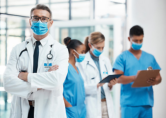 Image showing Medical doctors, nursing and healthcare nurses standing with covid masks for their safety in a hospital. Successful, professional and trustworthy medic expert with a stethoscope in an emergency room