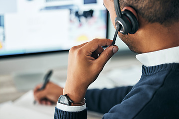 Image showing Call center, customer service and agent assisting online customer with a headset and taking notes. Closeup of a male financial consultant or telemarketer working on a computer to consult clients.