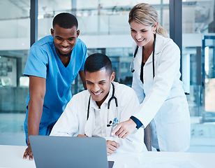 Image showing Doctors, medical professionals or healthcare workers with laptop talking, meeting or planning medicine treatment. Diverse group of happy clinic frontline colleagues researching virus cure in hospital