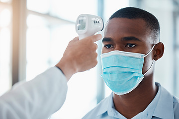 Image showing Man with covid taking temperature with thermometer at hospital, checking for fever and wearing face mask to prevent risk of virus. Face of male examining health with doctor and doing checkup
