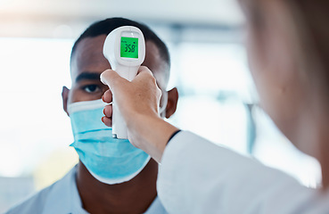 Image showing Temperature, thermometer and covid routine before entering office, workplace or company. Business man with mask checking fever by doctor or colleague to prevent spread of disease, illness or sickness