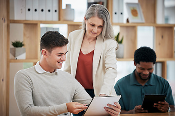 Image showing Elderly businesswoman leader, executive or mentor helping to coach and train new employees. Young intern getting help and coaching from professional business expert, CEO and boss in modern office