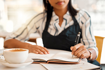 Image showing Writing, coffee shop owner and cafe entrepreneur with vision ideas, planning innovation and preparing schedule or menu. Closeup hands of restaurant barista using notebook or book to calculate finance
