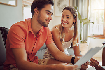 Image showing Bank loan approved, mortgage or home deposit is successful for a happy couple reading paperwork at home. Lovers planning financial budget and expenses or tax and are happy about salary