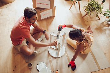 Image showing Recycle, thrift furniture and painter couple painting wooden table for new creative project in an apartment. Above view of man and woman working on DIY home improvement with a reusable craft object