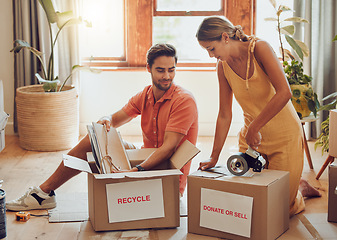 Image showing Donate, packing and boxes of a young couple working together to pack equipment at home. Relationship, togetherness and teamwork of a man and woman organizing their house for recycling