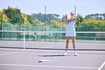 Image showing Fitness, tennis player and athlete stretching out arms before an exercise match, game or workout outside on the court. Young, active and sporty female in a sports club warming up ready for training