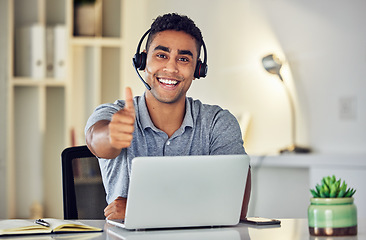 Image showing Thumbs up by call center, looking pleased and showing support with hand gesture while working on a laptop in an office alone at work. Portrait of an excited customer service agent expressing thanks