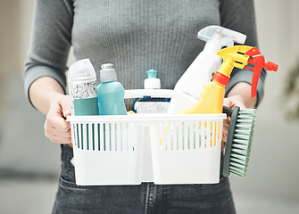 Image showing Woman, cleaner or housewife holding cleaning supplies, detergents and hygiene tools or products in a basket. Hands of a housekeeper ready to do chores and housework for a clean and tidy home