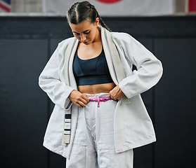 Image showing . Karate woman ready for fitness workout at gym, learning at a sport club and doing training exercise at a wellness school or studio. Female dojo student preparing for fighting competition at center.