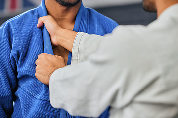 Image showing . Mma, fighting and martial arts with a teacher or instructor showing a student a grip or hold with his hands in a fight studio or sports gym. Closeup of a training workout in an exercise class.