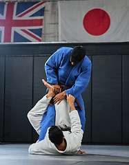 Image showing Martial arts, karate or judo fighters and athletes fighting in a competition, match or tournament. Japan vs UK, self defense and protection professionals with skill fight in a dojo to win and compete