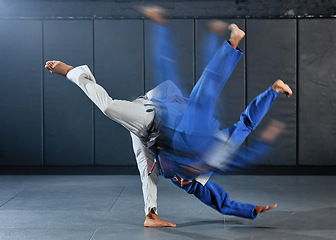 Image showing Fitness, strength and men in a karate fight in a gym for martial arts exercise. Action, motion and learning to take down the competition, training to overcome, fight failure and the motivation to win
