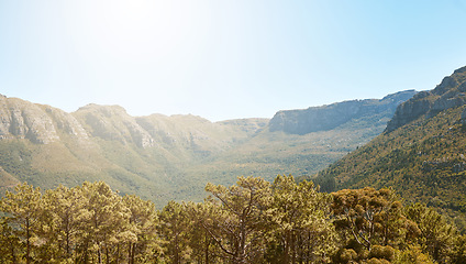 Image showing Landscape, mountain view and blue sky with copy space in remote countryside, eco nature and reserve for hiking, exploring and walking. Scenery of environmental and sustainable land with green forest