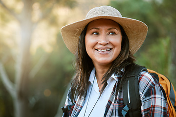 Image showing . Hiking, adventure and exploring with a mature female hiker enjoying a walk or hike in the forest or woods outside. Senior woman walking on a journey of discovery in nature in the great outdoors.