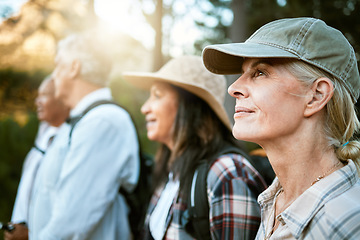 Image showing . Hiking, adventure and exploring with a group of senior friends enjoying a walk or nature hike in the forest or woods outdoors. Closeup of mature retired people on a journey for outside discovery.