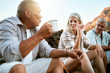 Image showing Carefree, adventure and exploring friends talking, bonding and enjoying relaxing outdoors. Senior group enjoying a break after hiking in the forest, mountains or woods together having drinks or snack