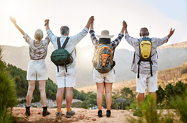 Image showing Celebrating freedom, fun and hiking with a group of senior friends taking a mountain hike and enjoying the view. Rearview of retired friends spending time together and bonding in the forest or woods