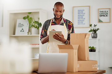 Image showing . Small business owner or creative startup entrepreneur checking an online order. Fashion, style and design with a trendy designer and tailor working on a tablet in his textile workshop or studio.