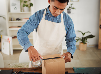 Image showing Creative tailor closing order for shipping, seamstress packing product in a box for delivery and designer preparing a package at a shop. Male business owner, employee and courier working in a studio