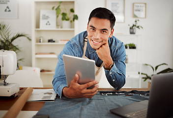 Image showing Looking for fashion design ideas on tablet, planning creative clothing and working on website online while in a factory at work. Portrait of smiling designer, stylist or tailor at a shop for clothes