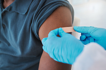 Image showing Corona, compliance and the vaccine being given to man by a health care worker. Closeup of a nurse putting a plaster on a man after an injection or treatment. Male making decision to get booster shot