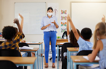 Image showing Teacher asking questions to school kids who are eager, smart and clever for education in covid pandemic. Students raising hand to volunteer, join and answer educator in class lesson for learning
