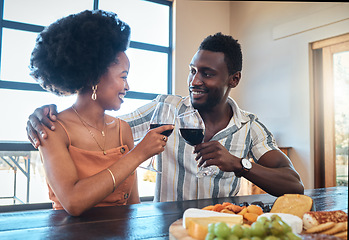 Image showing Celebration, love and black couple toasting with wine on a romantic date indoors, bonding and flirting. Lovers happy, in love and carefree, celebrating their anniversary and sharing intimate moment