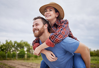 Image showing Playful, agriculture farmer couple having fun on a farm, countryside or nature environment enjoying rustic, sustainable living lifestyle. Happy, caring and in love husband giving wife piggyback ride