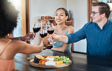 Image showing Friends, fun and celebration with diverse group toasting with red wine to good news, bonding at a restaurant. Young friends reunion, happy to be together and enjoy wine tasting with charcuterie board