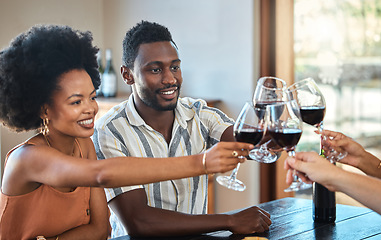 Image showing Black couple celebrating their anniversary with friends, toasting and drinking red wine. Happy girlfriend and boyfriend bonding at a family gathering, together for an engagement or proposal