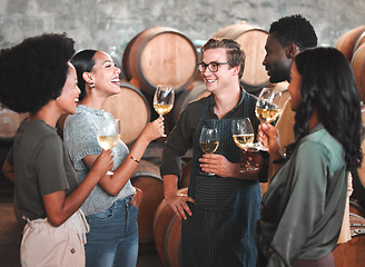 Image showing Group of friends wine tasting at a distillery or cellar drinking glasses and enjoying the tour together. Happy, carefree and diverse people bonding and having fun at a winery estate