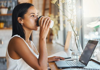 Image showing Young freelance worker drinking coffee and working on a laptop in a cafe. Woman entrepreneur reading work or business email online with technology. Motivated for growth in ecommerce startup company