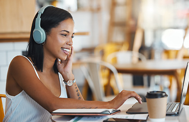 Image showing Happy student relaxing, studying or searching online videos on her laptop at a coffee shop with free internet. Young woman at a cafe store listening to music, radio or podcast news entertainment